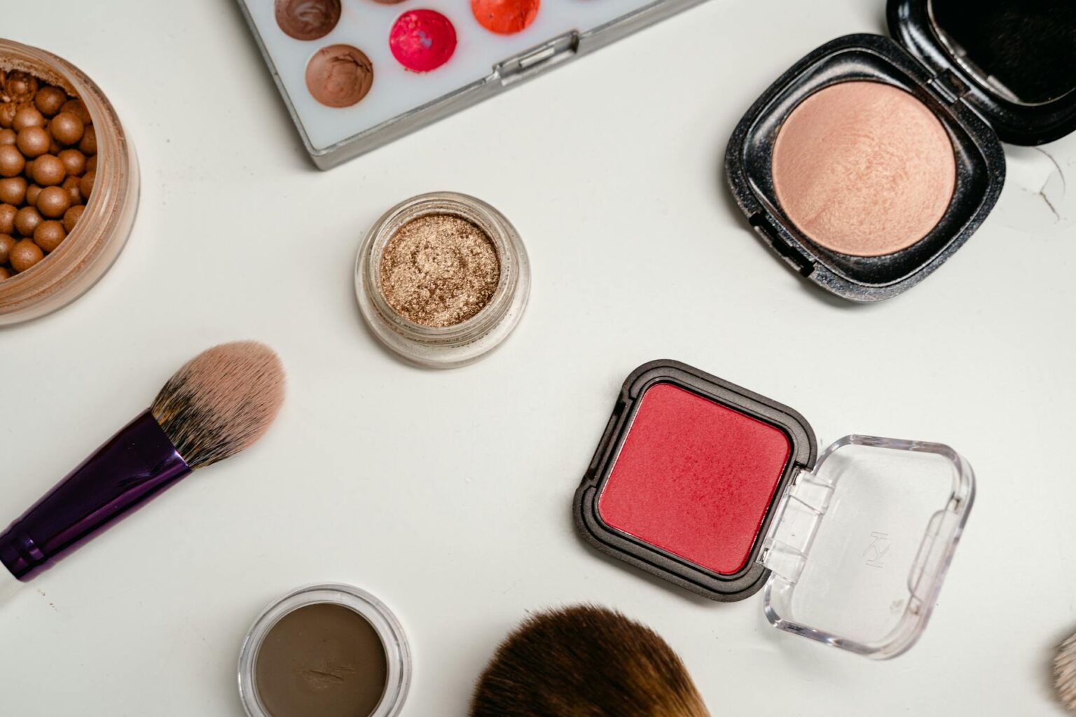 Assorted Korean beauty makeup products arranged on clean white surface