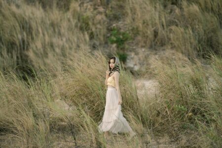 Woman wearing flowing white maxiskirt in summer setting