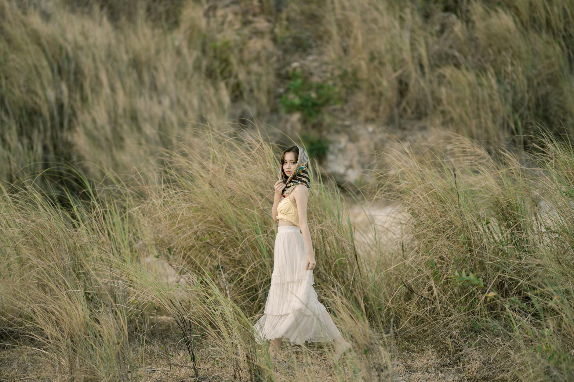 Woman wearing flowing white maxiskirt in summer setting