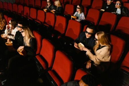 People watching a movie in a darkened theater with projected light