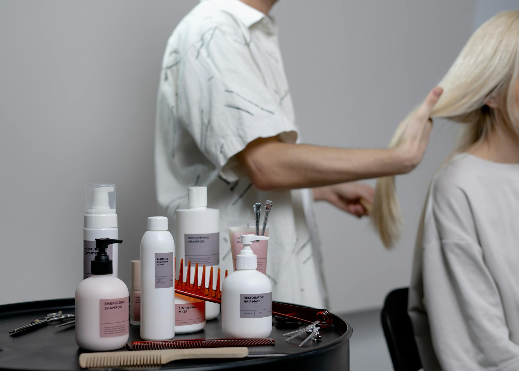 Modern hair care bottles and treatments arranged on clean surface