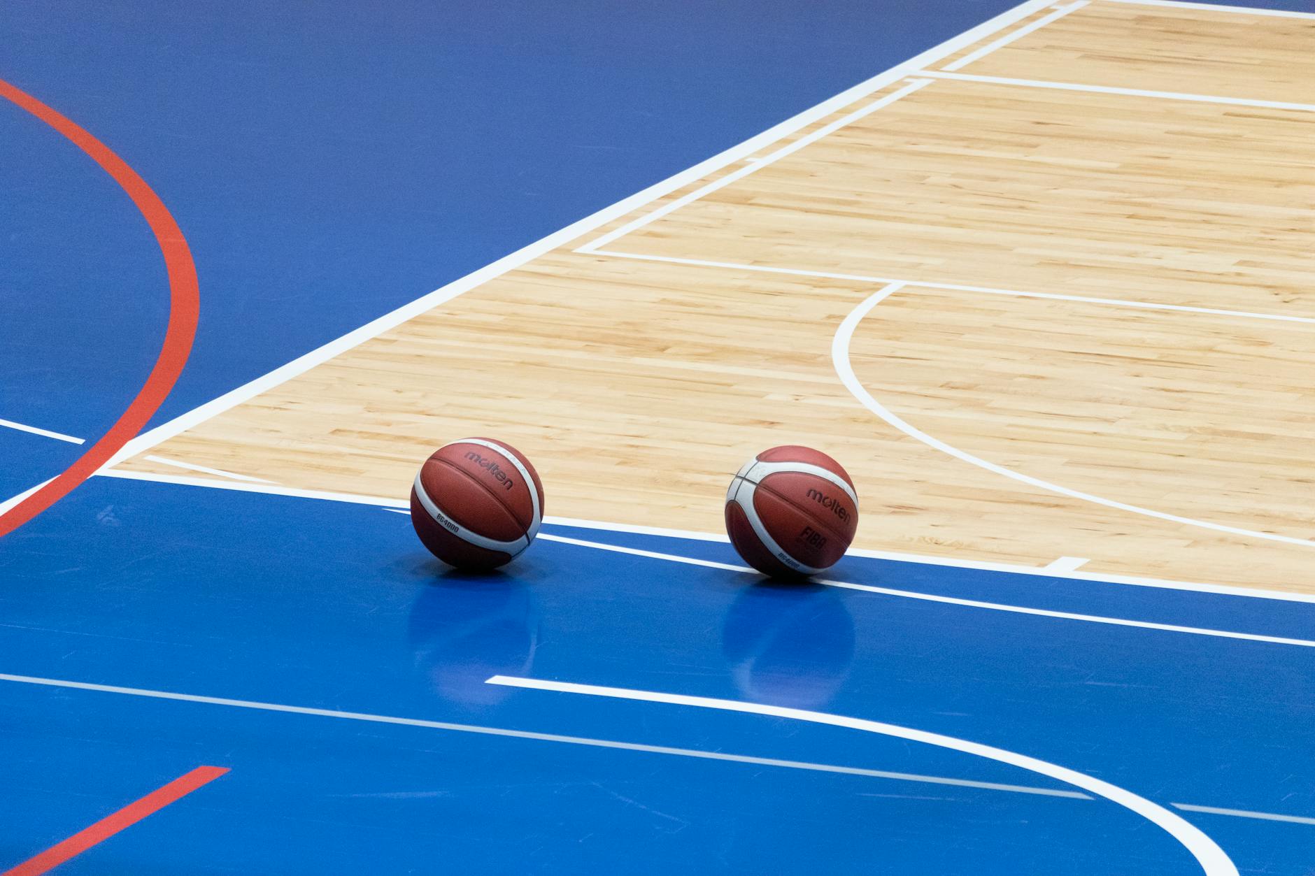 Professional basketball court with bright arena lighting and empty seats
