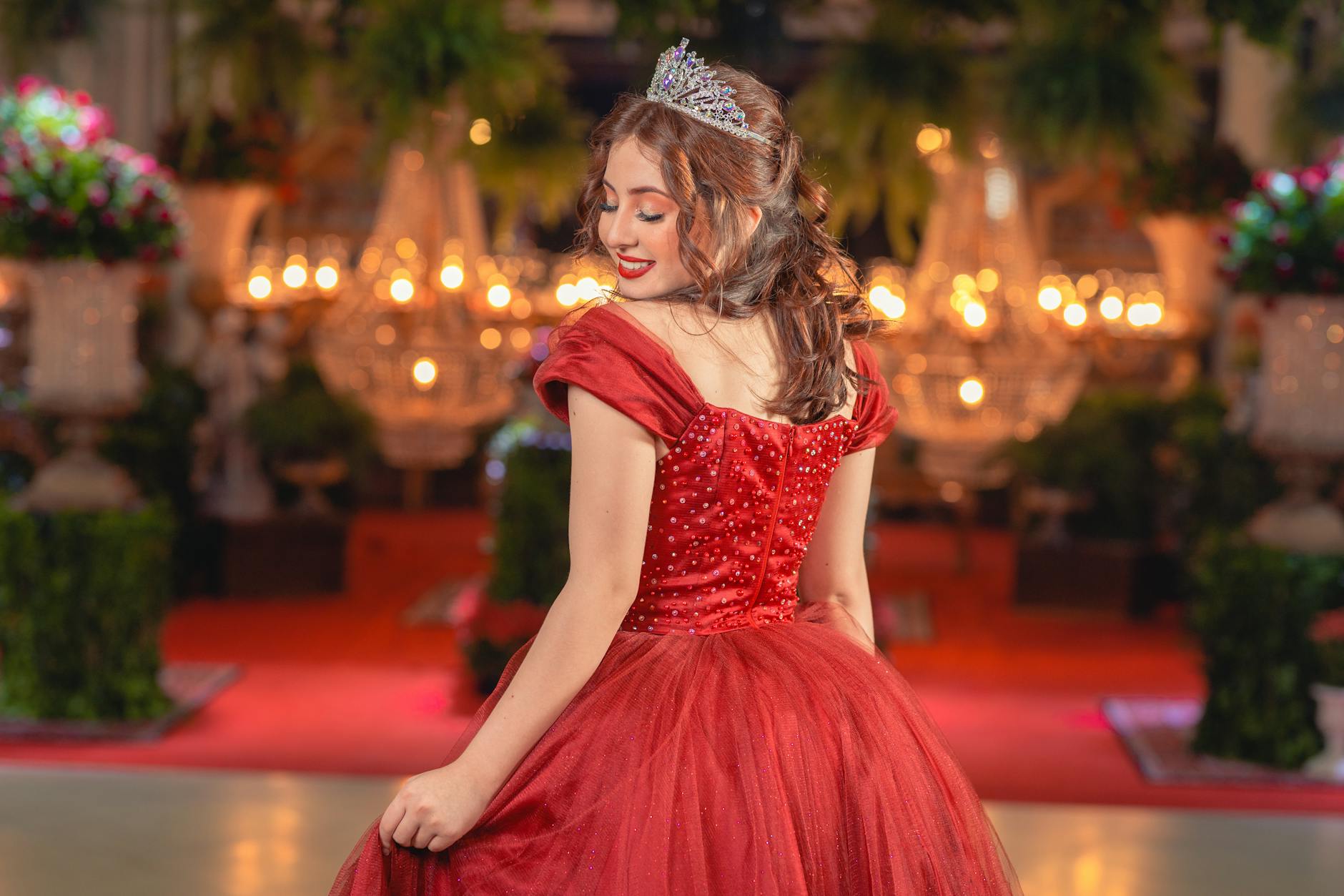 Red carpet with velvet ropes and camera flashes in background