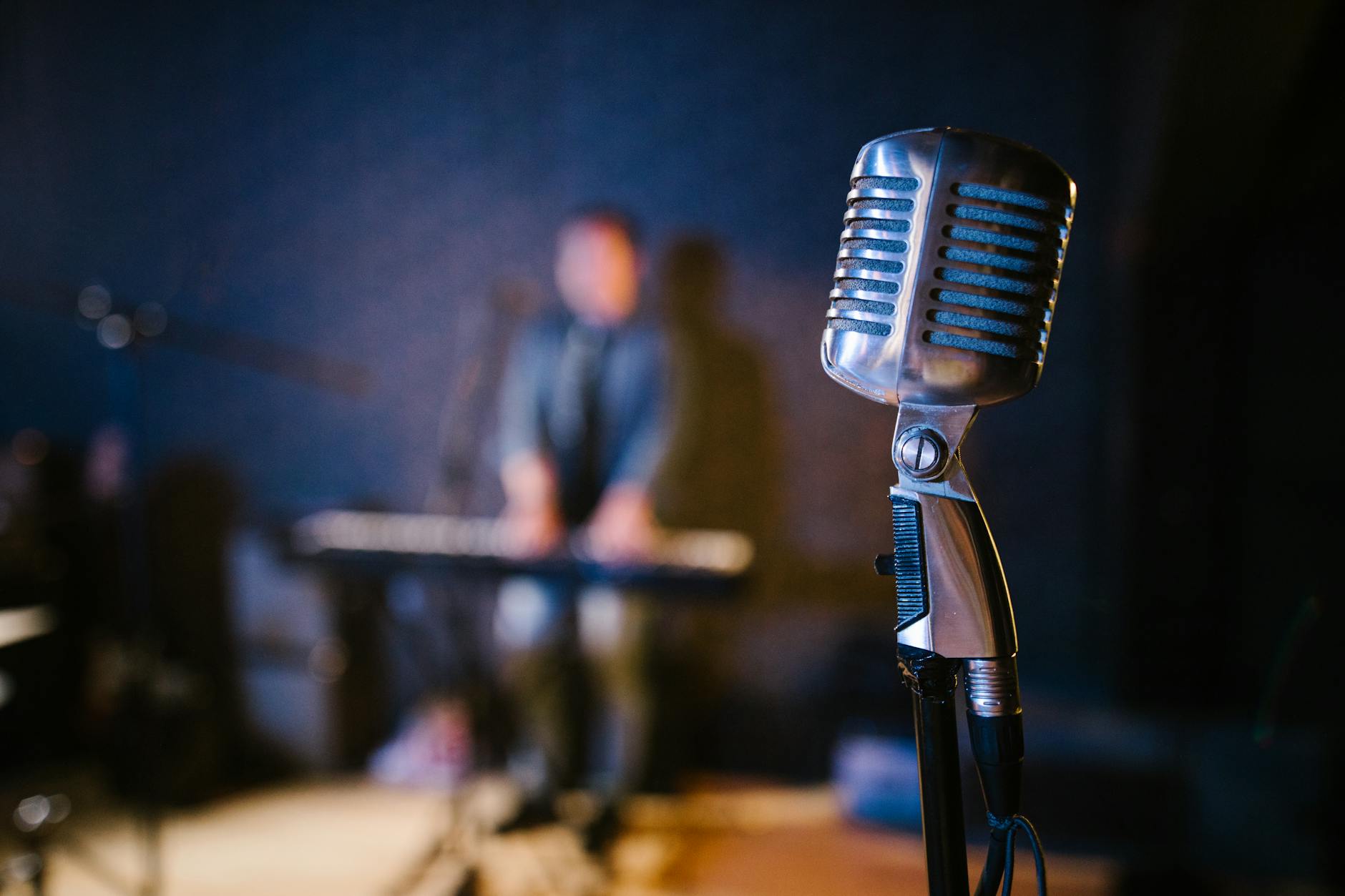 Professional vintage microphone on dark stage with spotlight