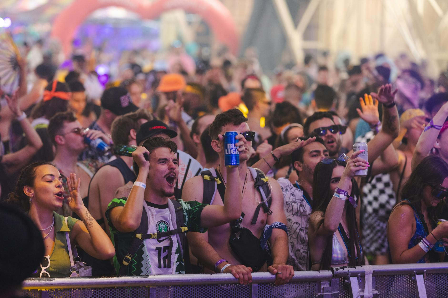 Festival attendees wearing bohemian white clothing at outdoor event