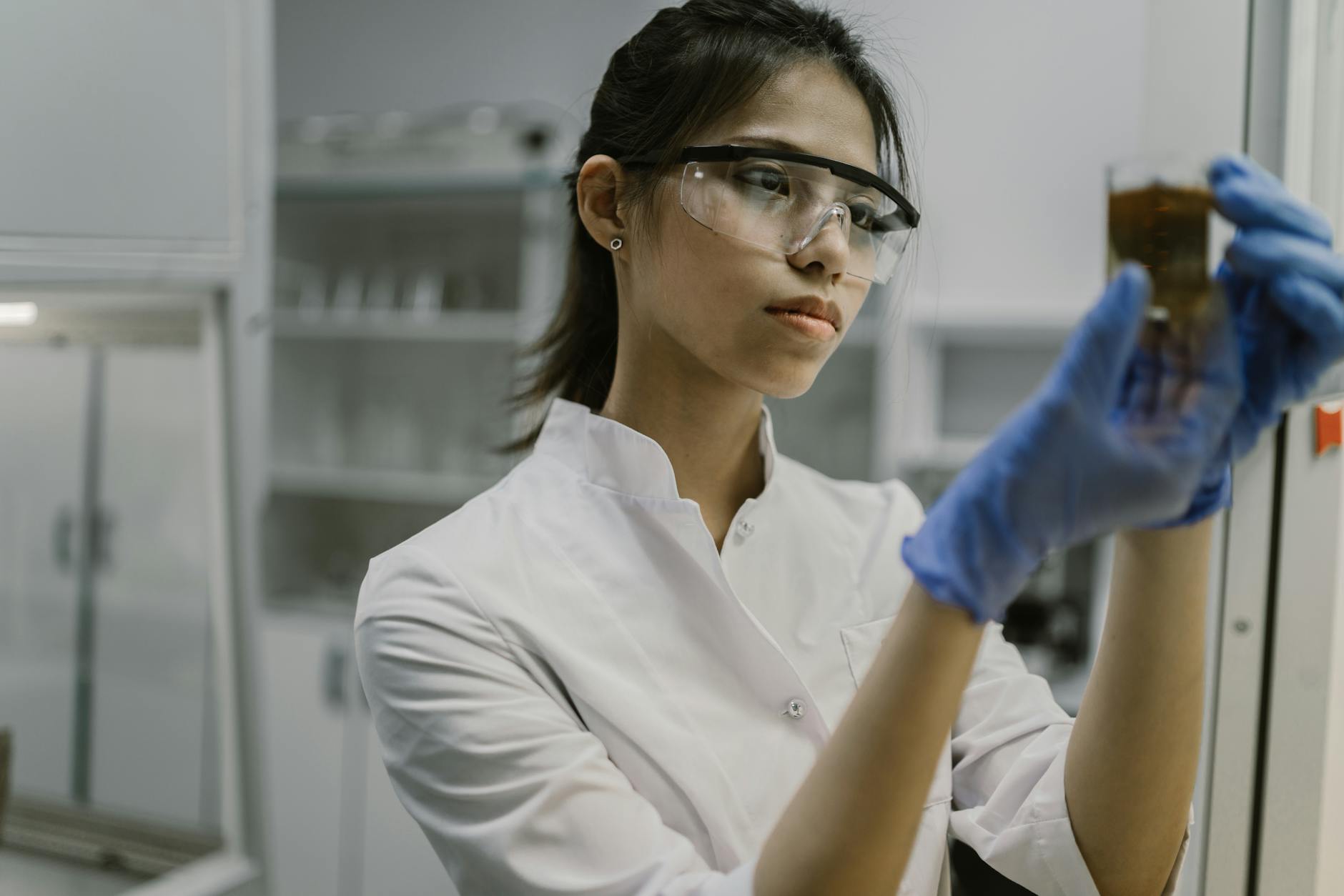 Researcher examining data in laboratory setting