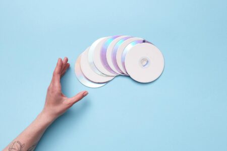 Stack of colorful music CDs arranged on a wooden surface