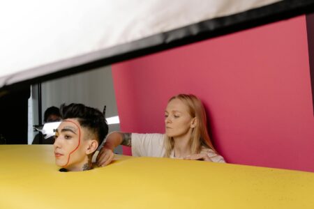 Professional makeup artist applying cosmetics with precise brush strokes