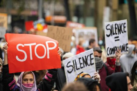 Activists holding protest signs during street demonstration