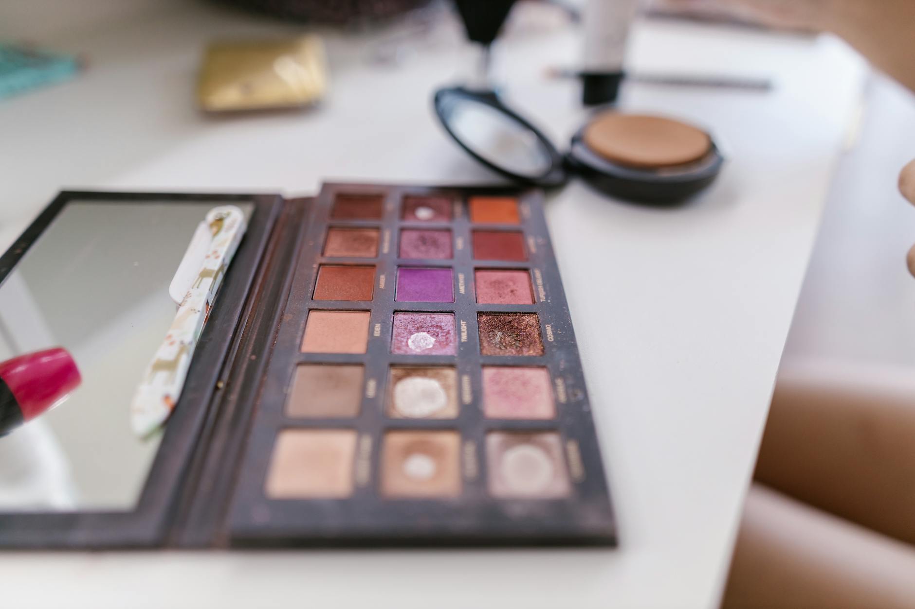 Colorful eyeshadow palette with multiple shades arranged in compact case