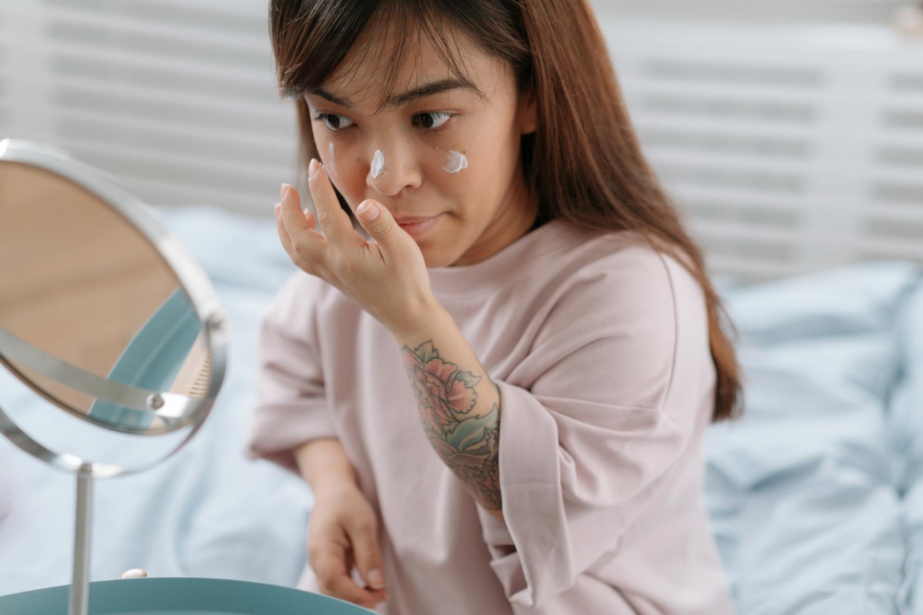 Woman applying skincare products during morning routine