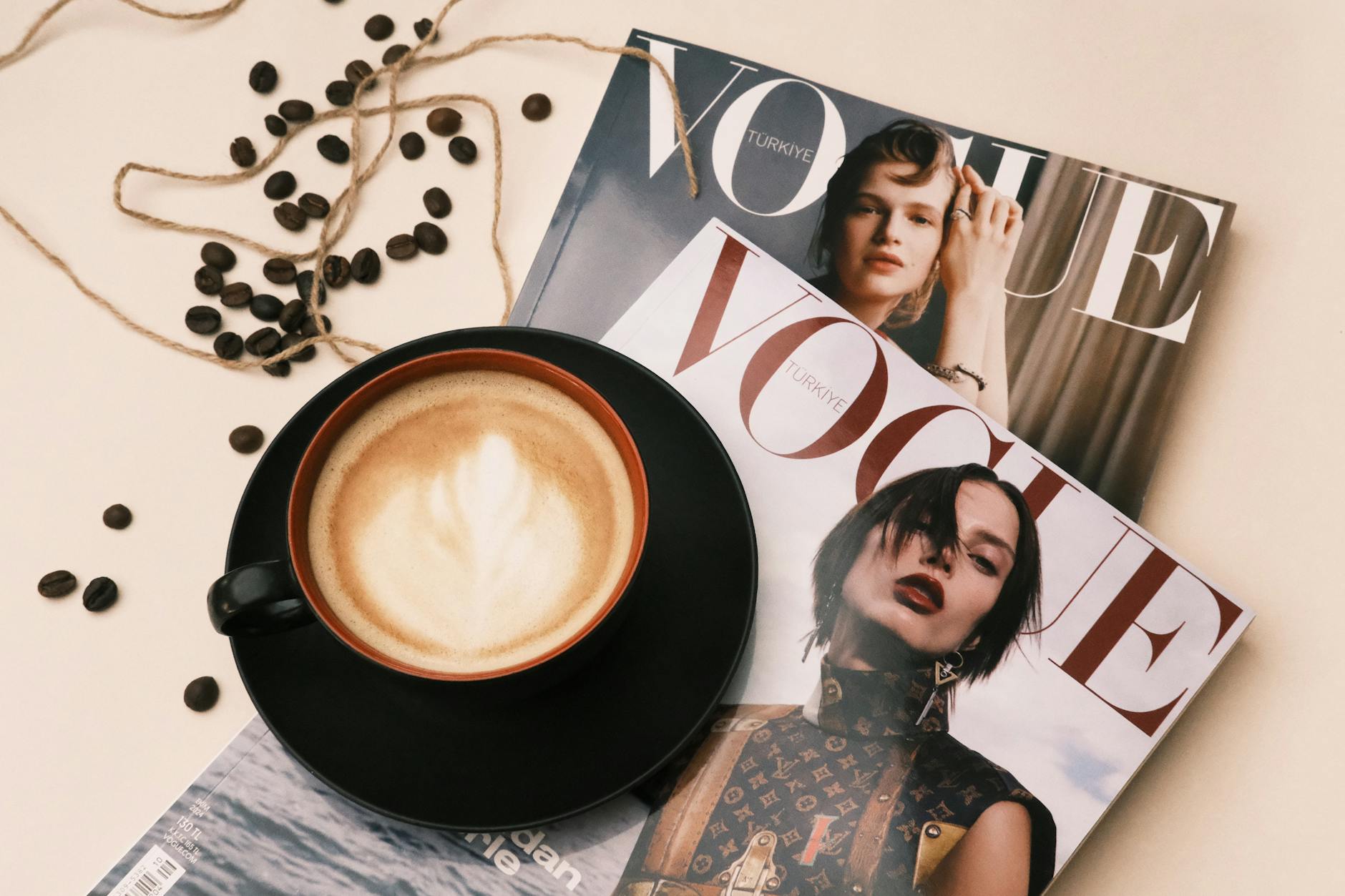 Fashion magazines spread across a desk