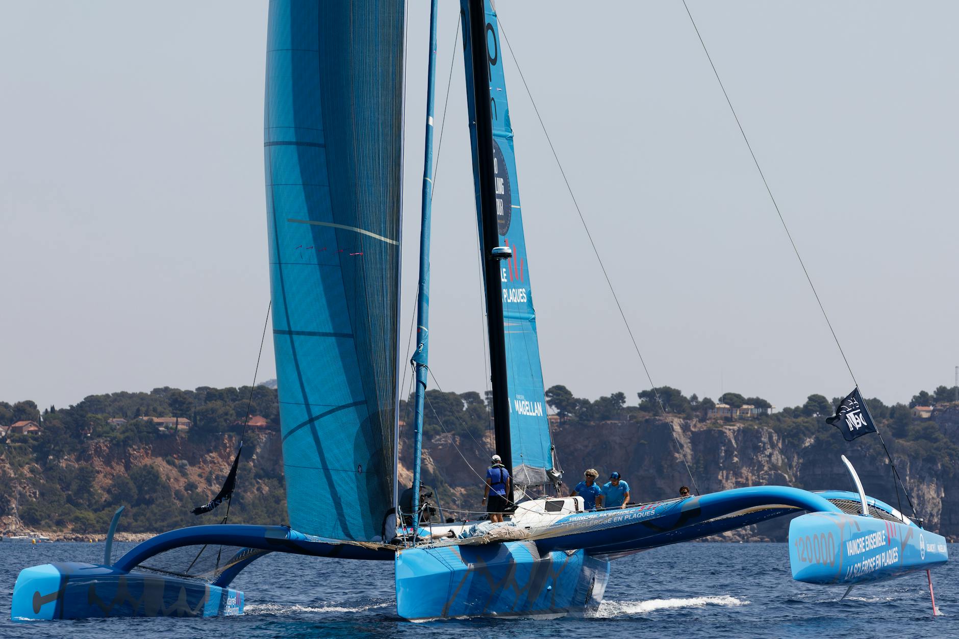 High-speed catamaran sailing boat lifting out of water during race