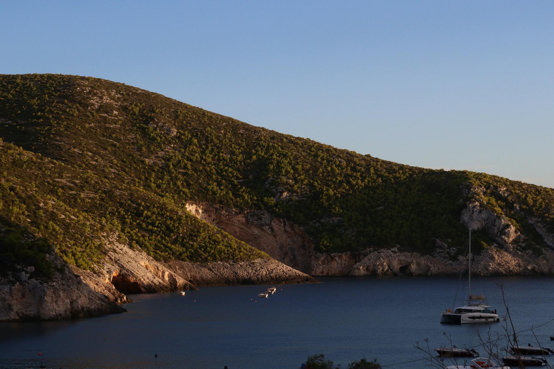 Sunlit coastal village in Greece with white buildings and blue water