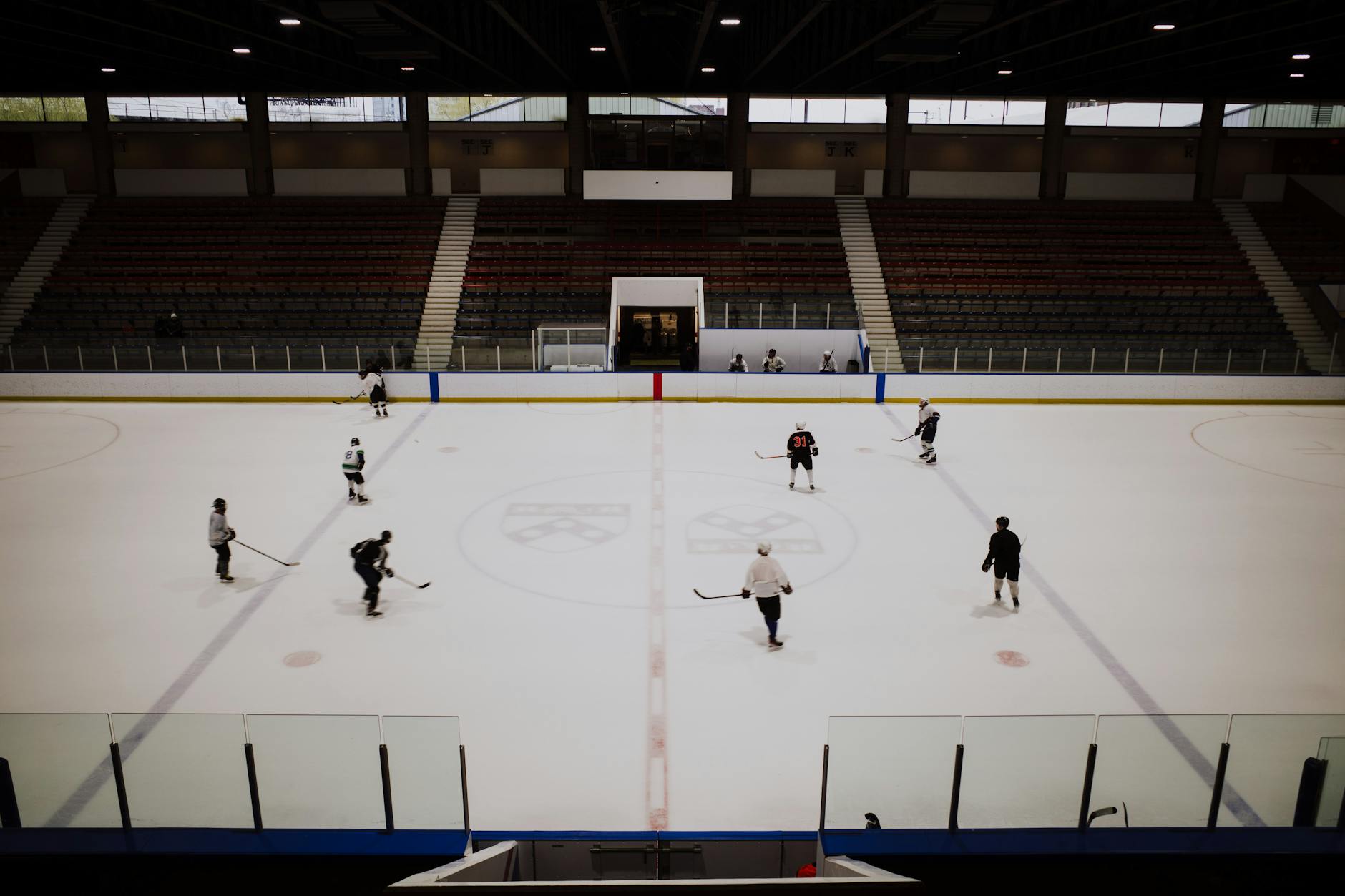 Empty ice hockey rink with arena lighting overhead