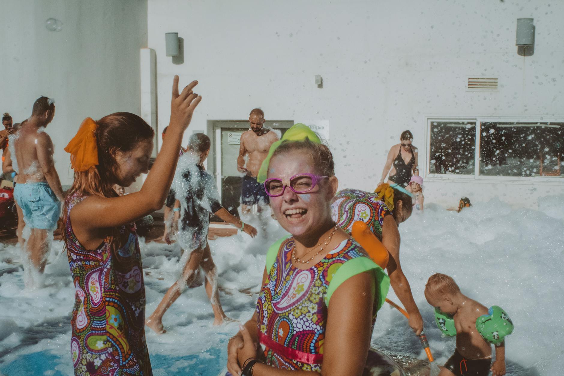 People enjoying poolside gathering in summer swimwear
