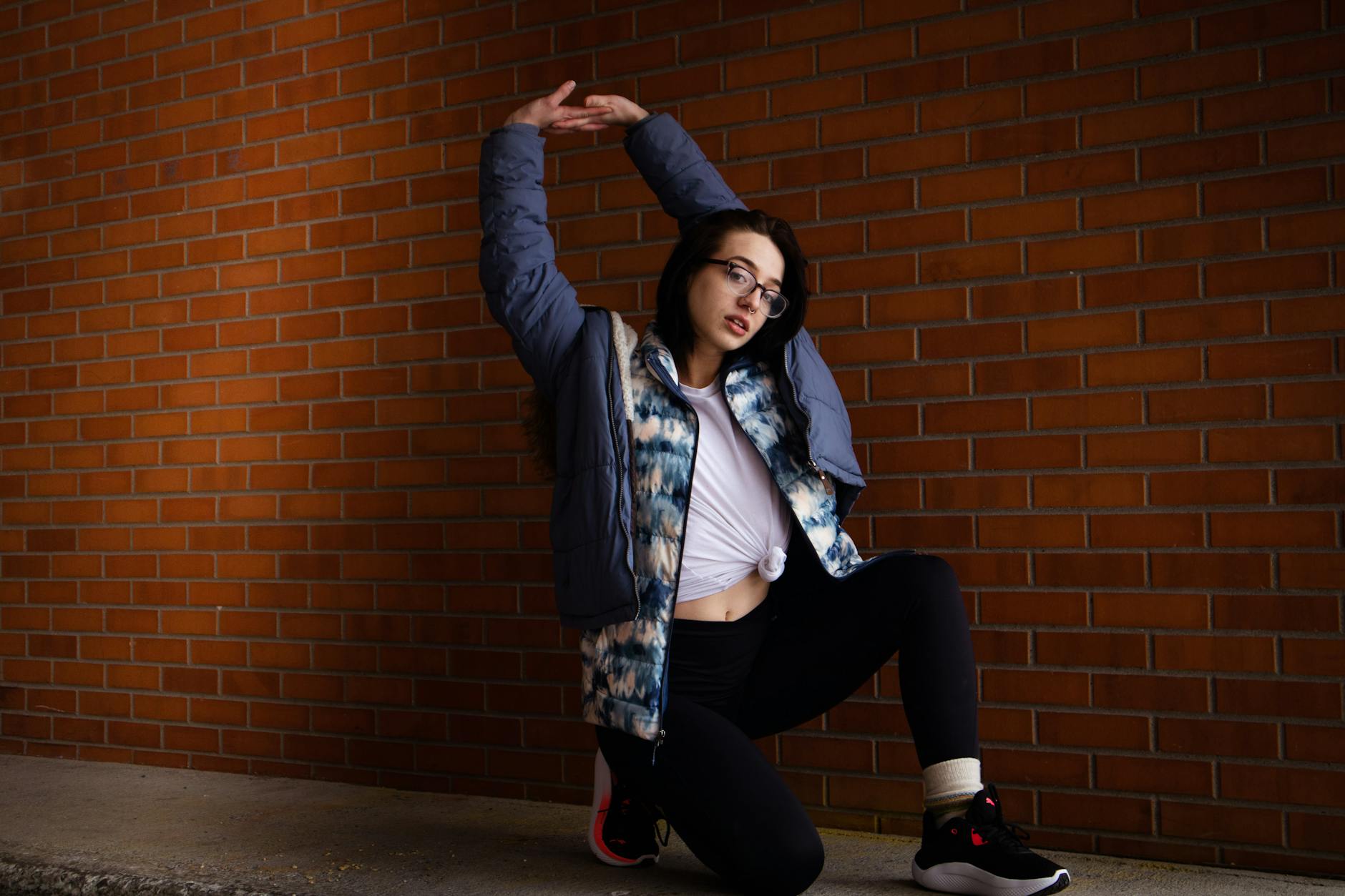 Model wearing athletic windbreaker jacket in urban environment