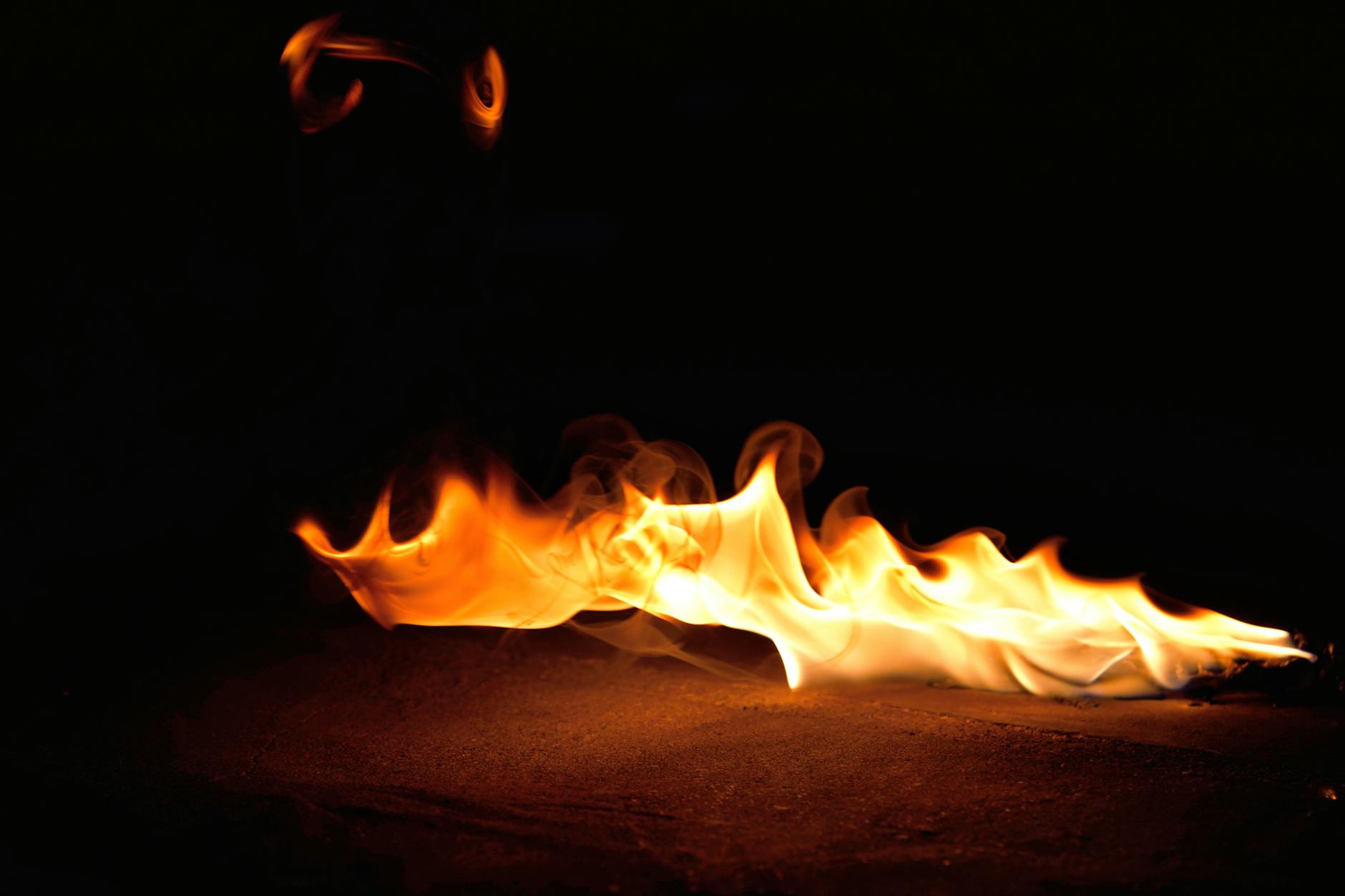 Dark flames symbolizing the traumatic fire from the characters' past