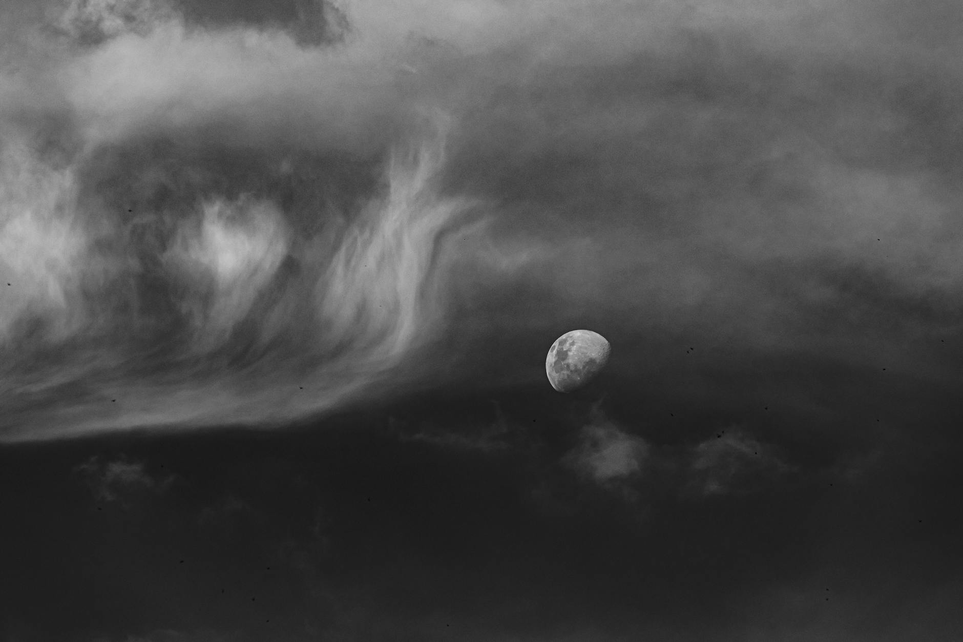 Close-up of a full moon against a dark atmospheric sky