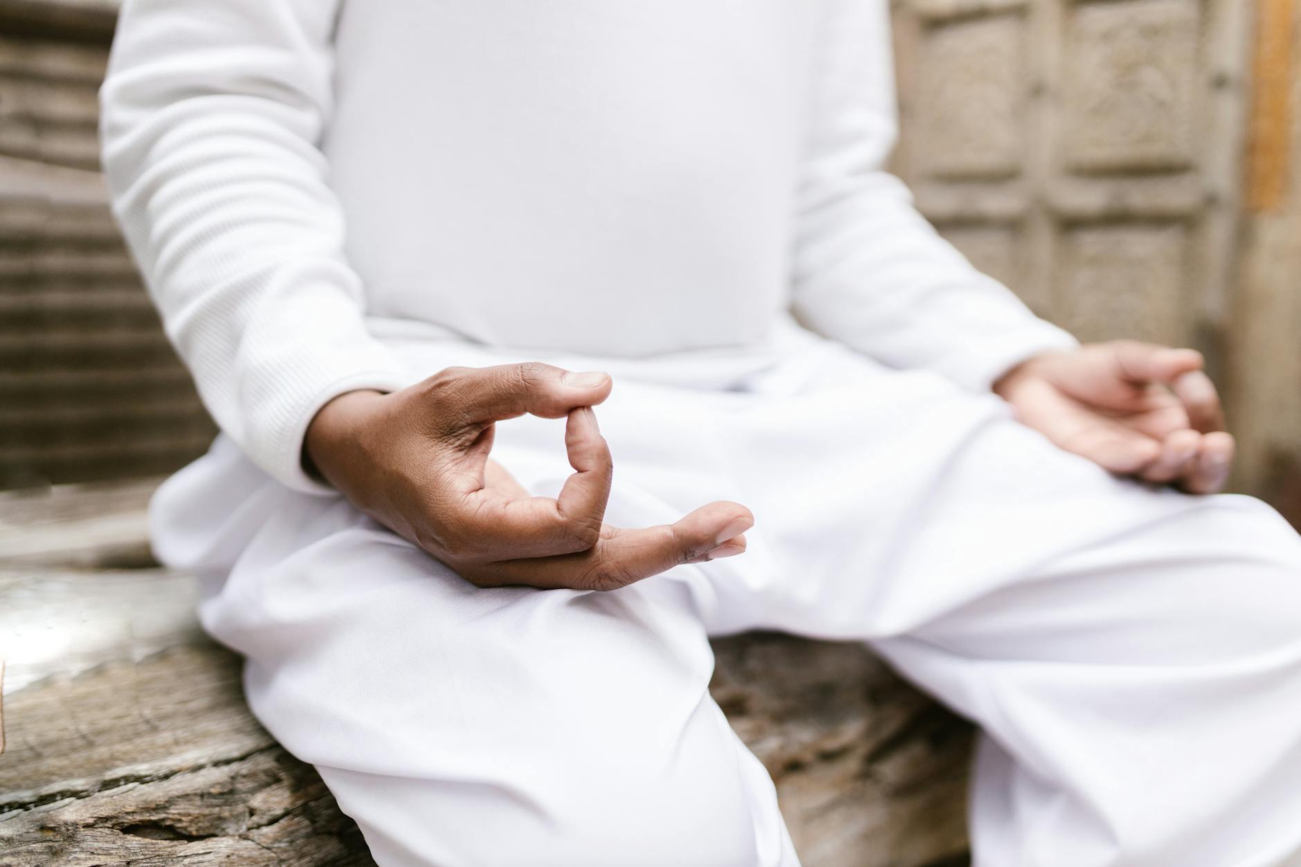 Person sitting quietly in contemplative pose during peaceful moment