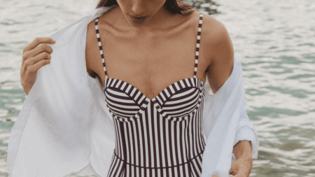 Woman in one-piece swimsuit by swimming pool