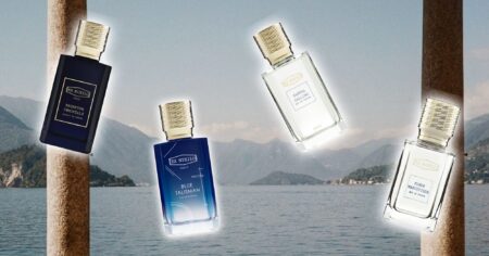 Elegant perfume bottles arranged on marble surface