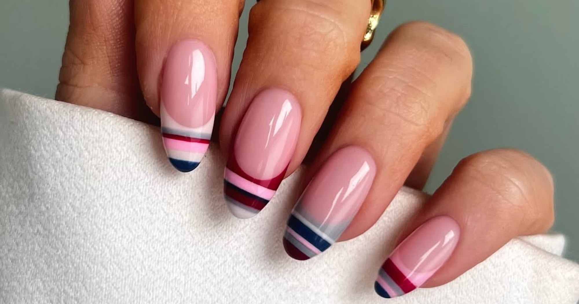 Close-up of hands with colorful nail polish and manicure tools