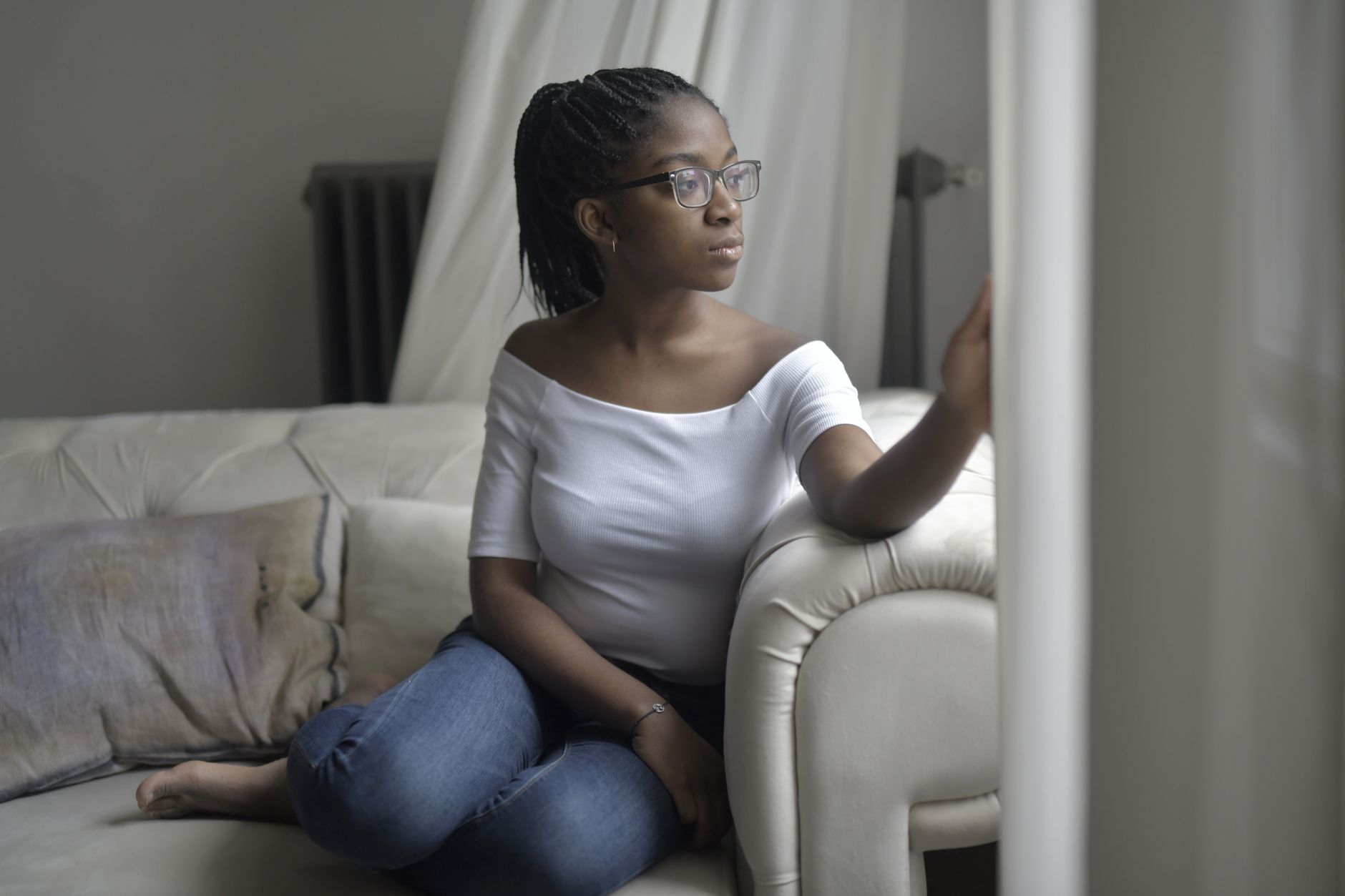 A woman gazing out a window in quiet reflection