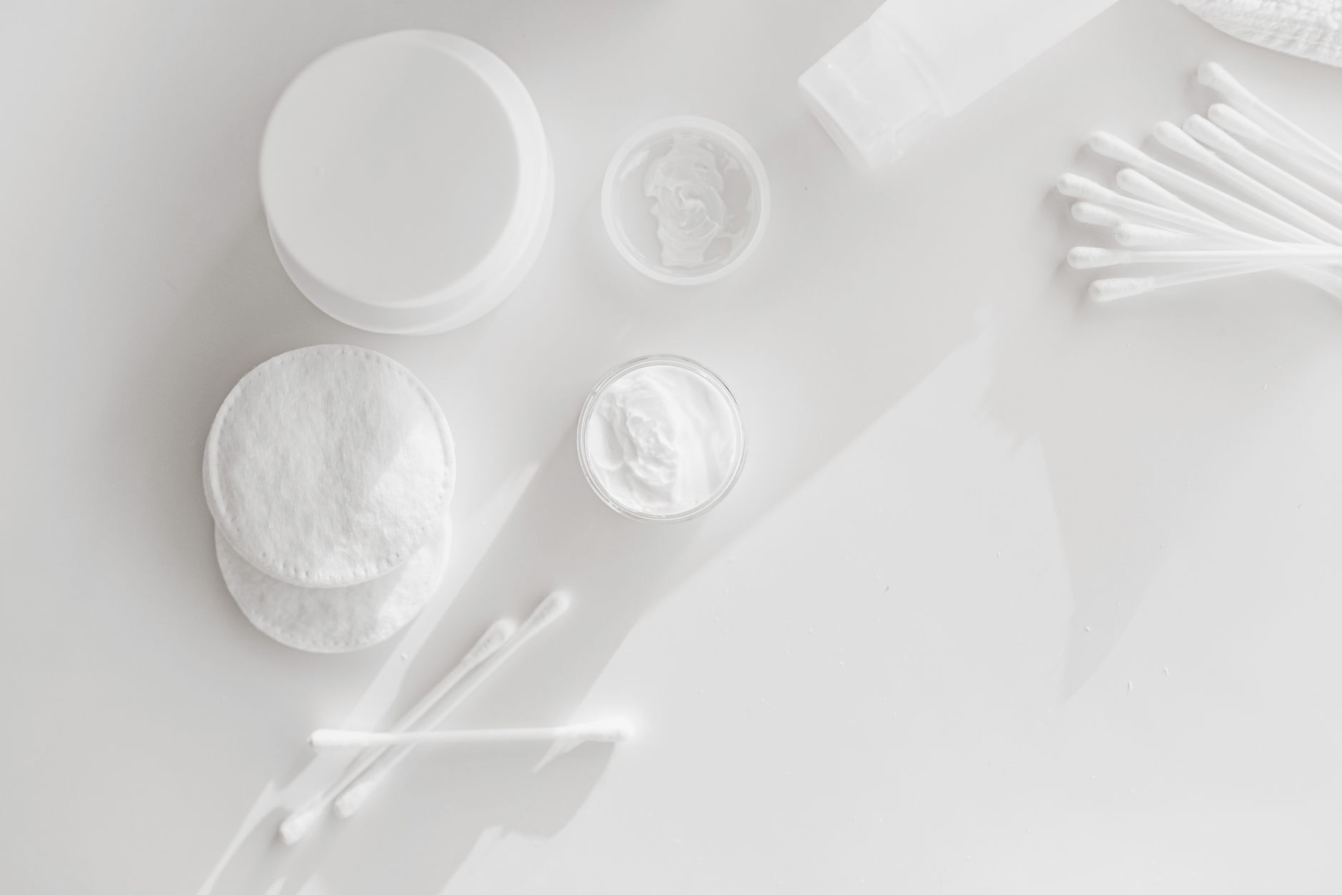 Close-up of a person applying an exfoliating pad to their face during a skincare routine