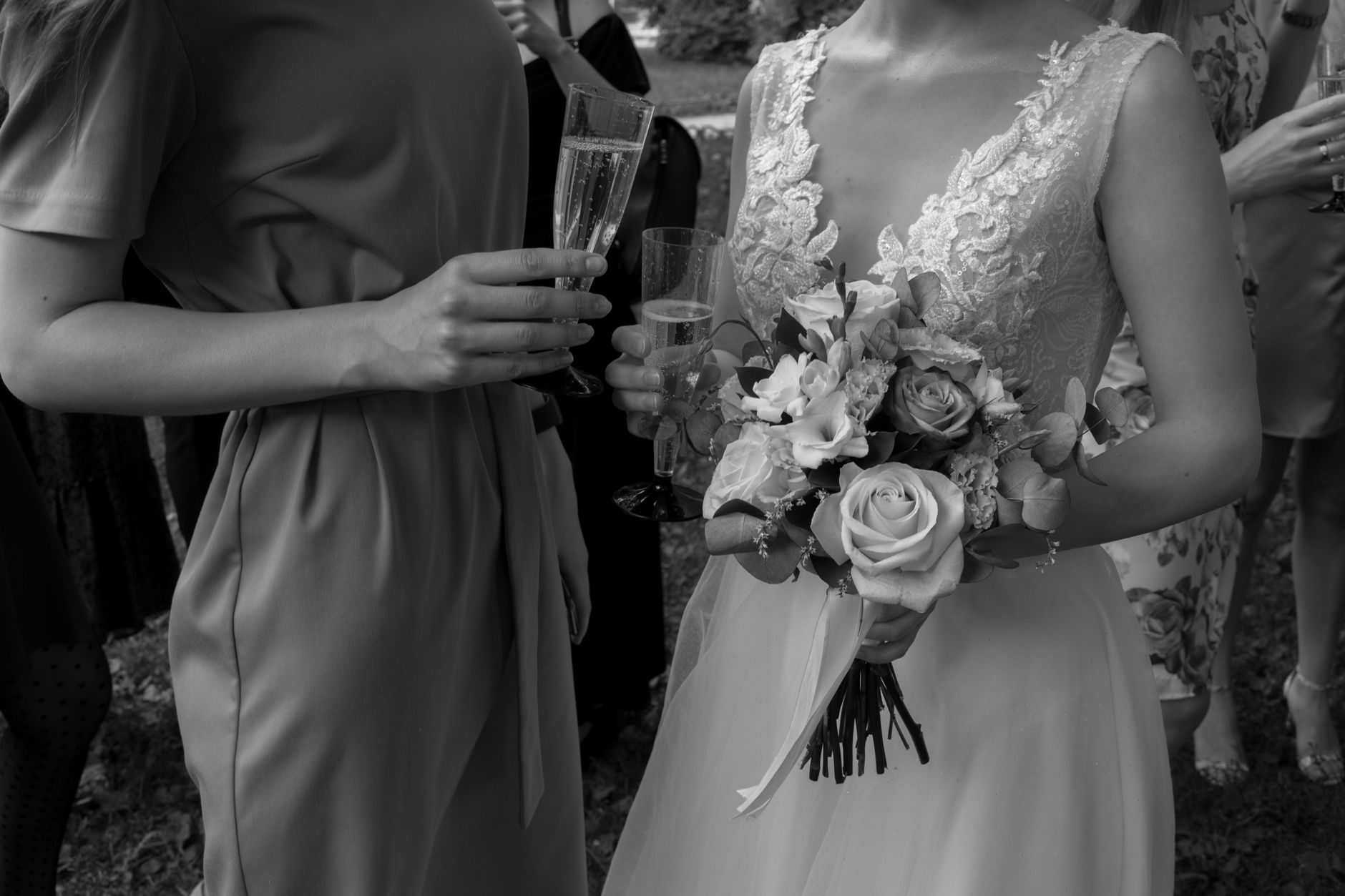 Elegantly dressed wedding guest in a bold-colored gown at an outdoor ceremony