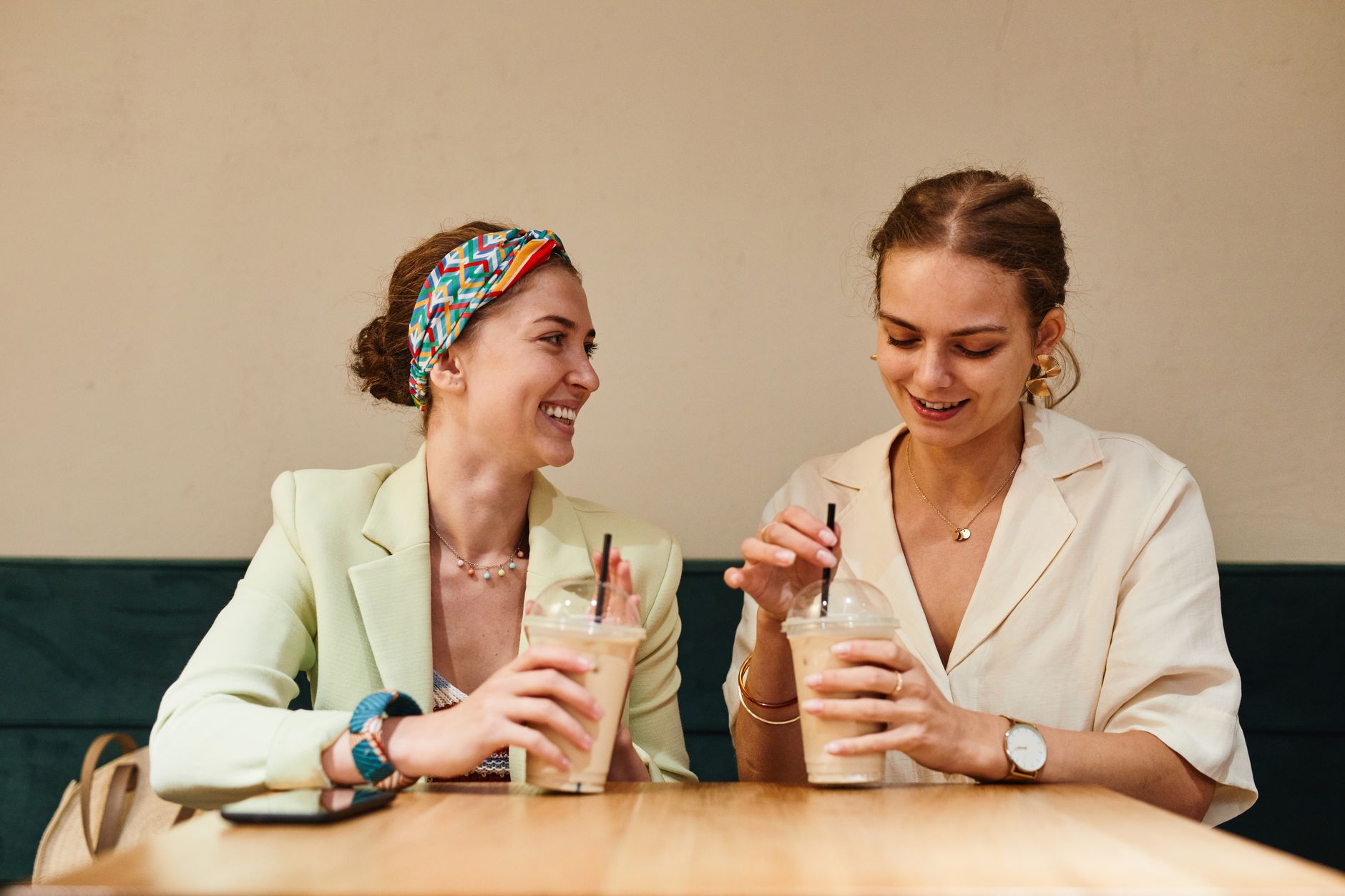 Two women talking over coffee, evoking the close friendship dynamic central to Gilmore Girls