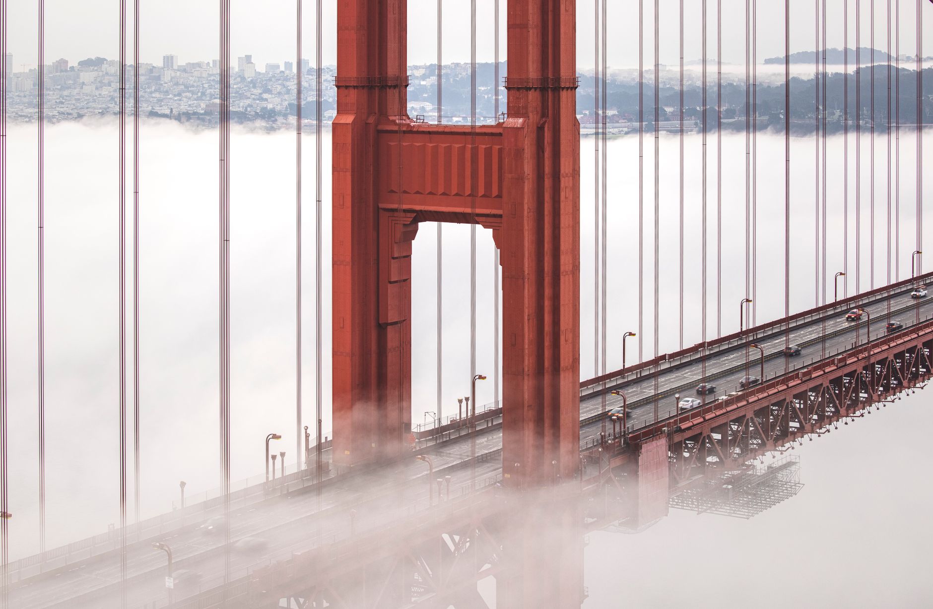 Golden Gate Bridge partially obscured by morning fog in San Francisco