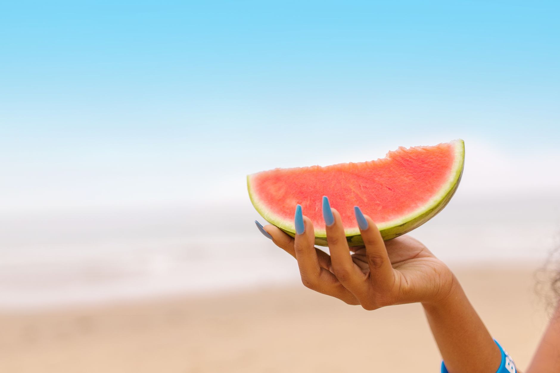 Bright summer nail designs featuring blue and white stripe patterns with red accents