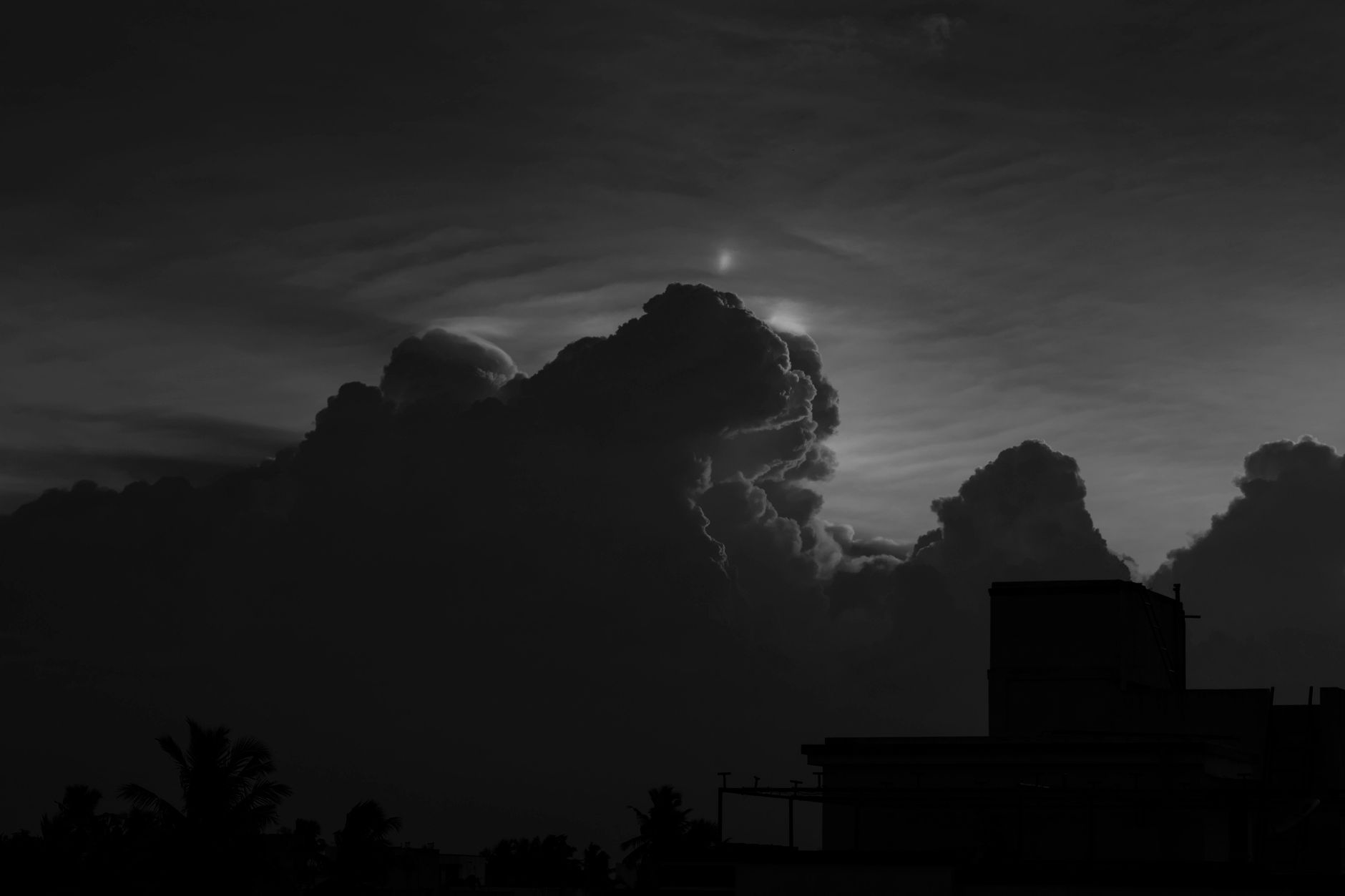 A dramatic night sky with glowing celestial bodies visible above the horizon