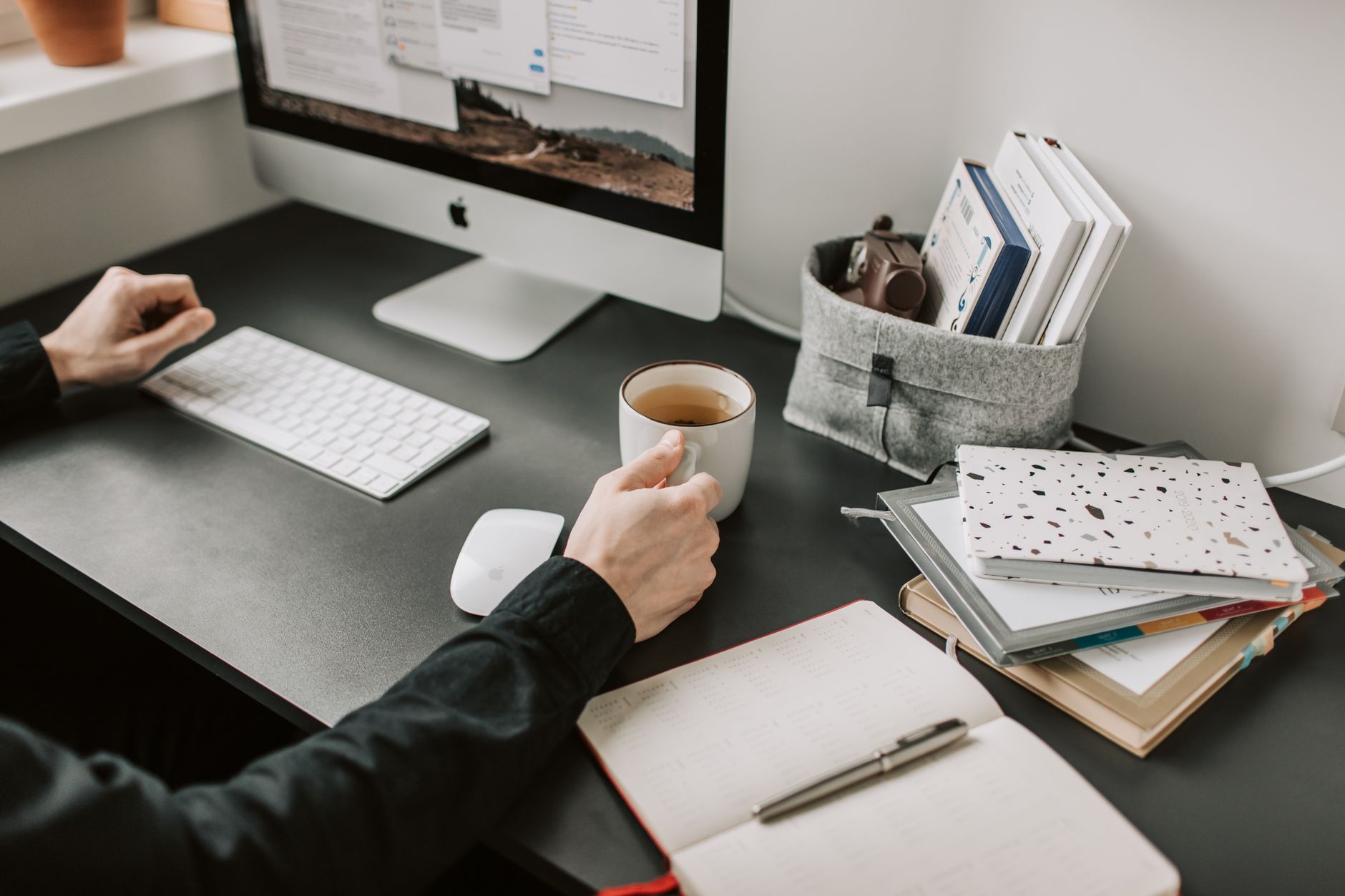 Person working independently at a clean desk with focused expression