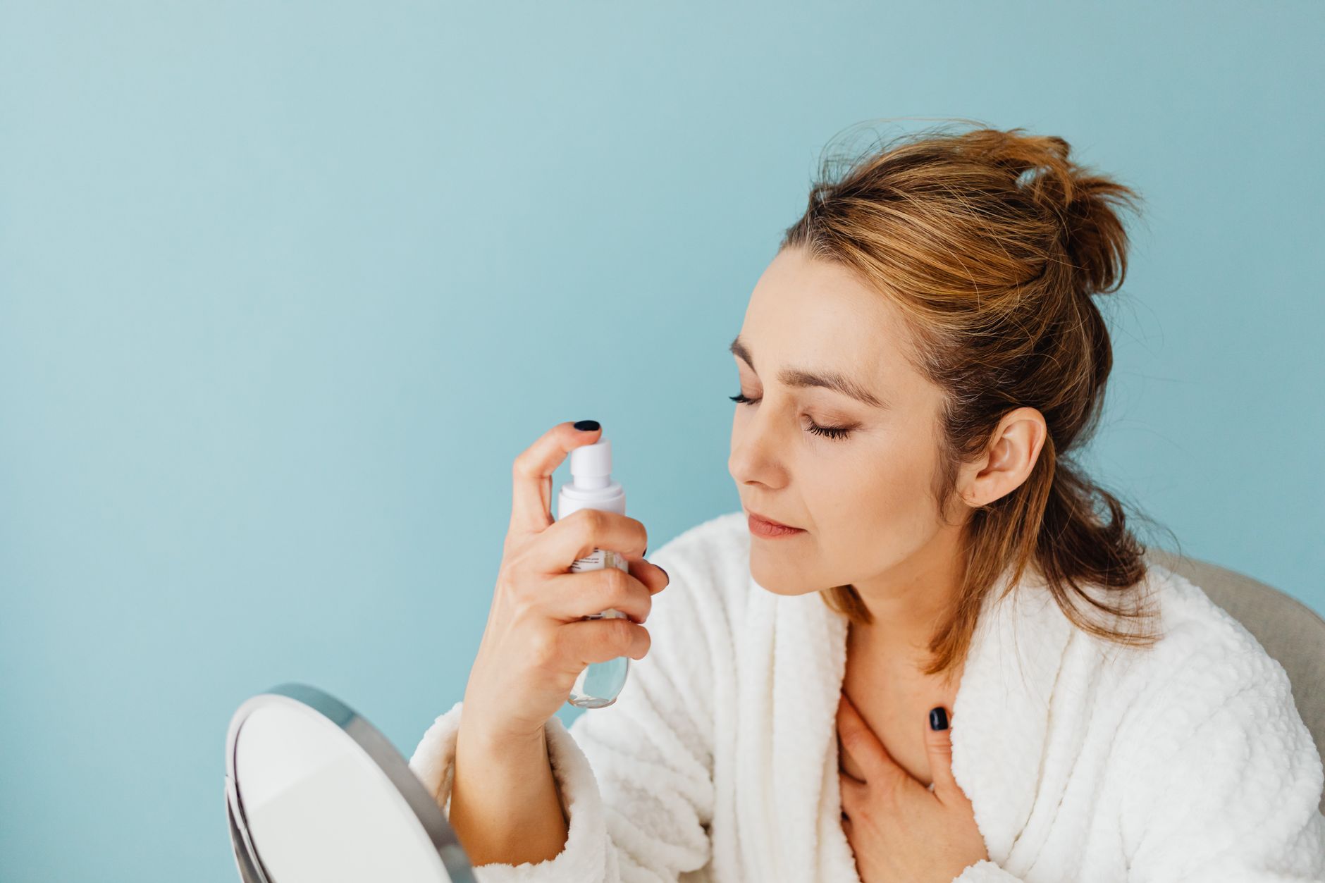 Close-up of a cosmetic spray bottle on a clean surface