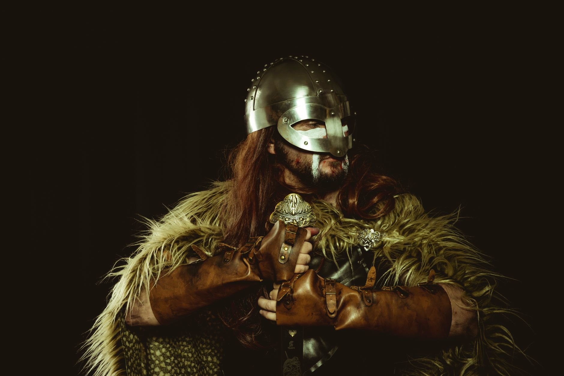 Dramatic fantasy warrior in costume against a dark background