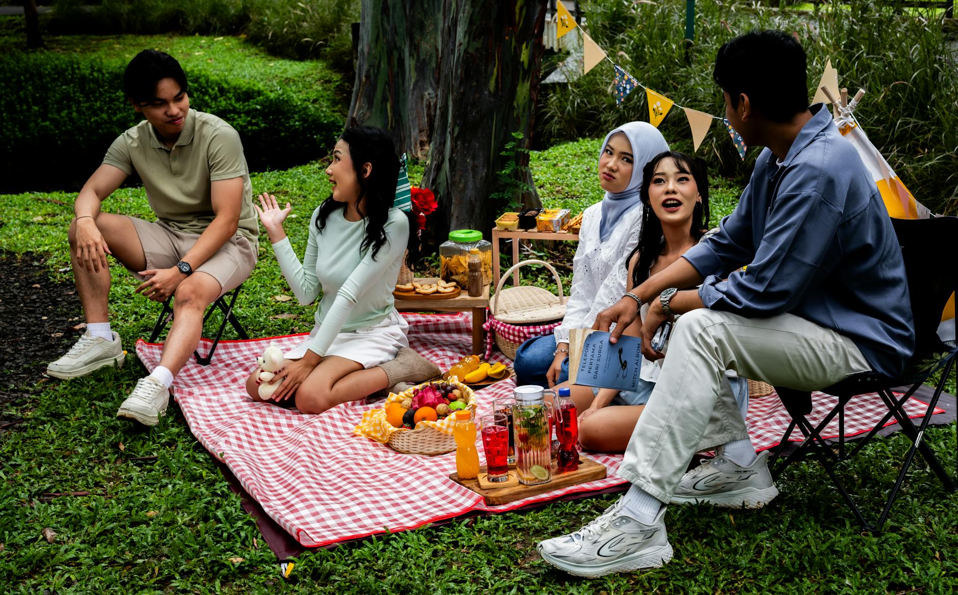 Small group of friends gathered outdoors in conversation, laughing together