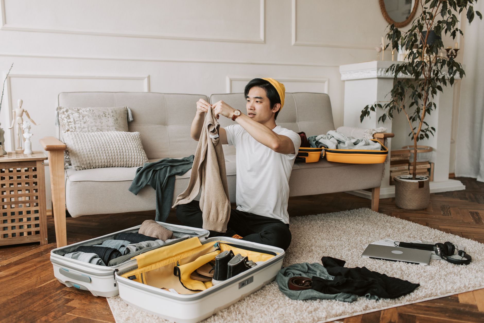 Summer clothing and accessories laid out for travel packing