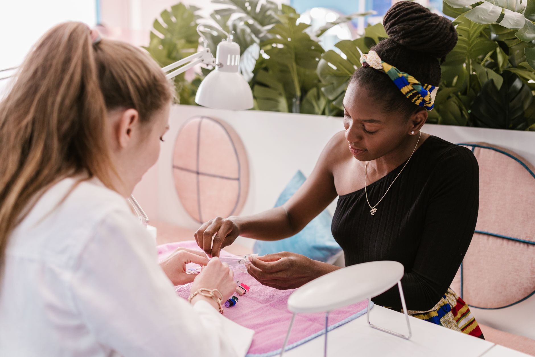 Nail technician working on a detailed manicure in a salon setting