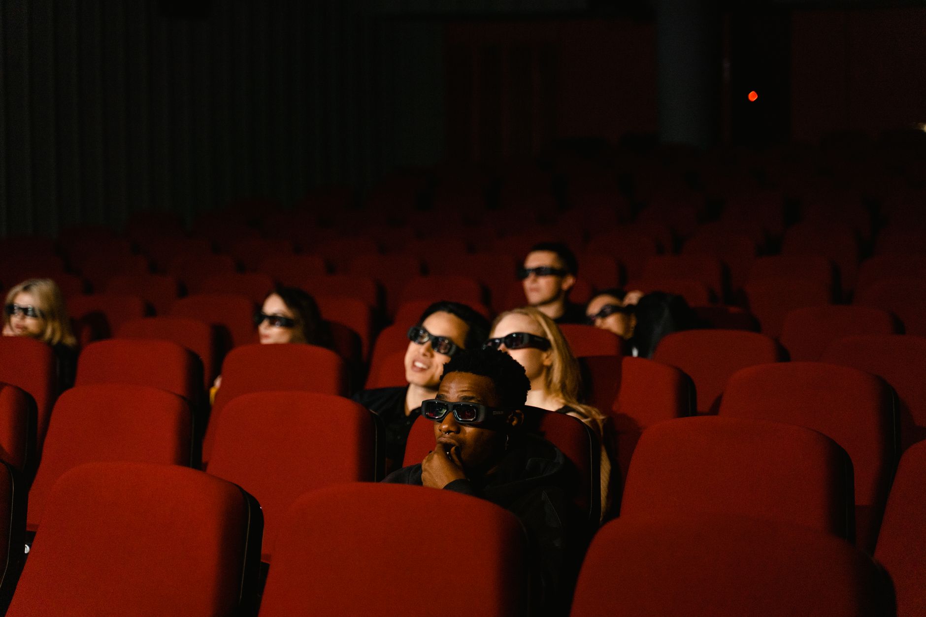 Moviegoers watching a film in a darkened theater