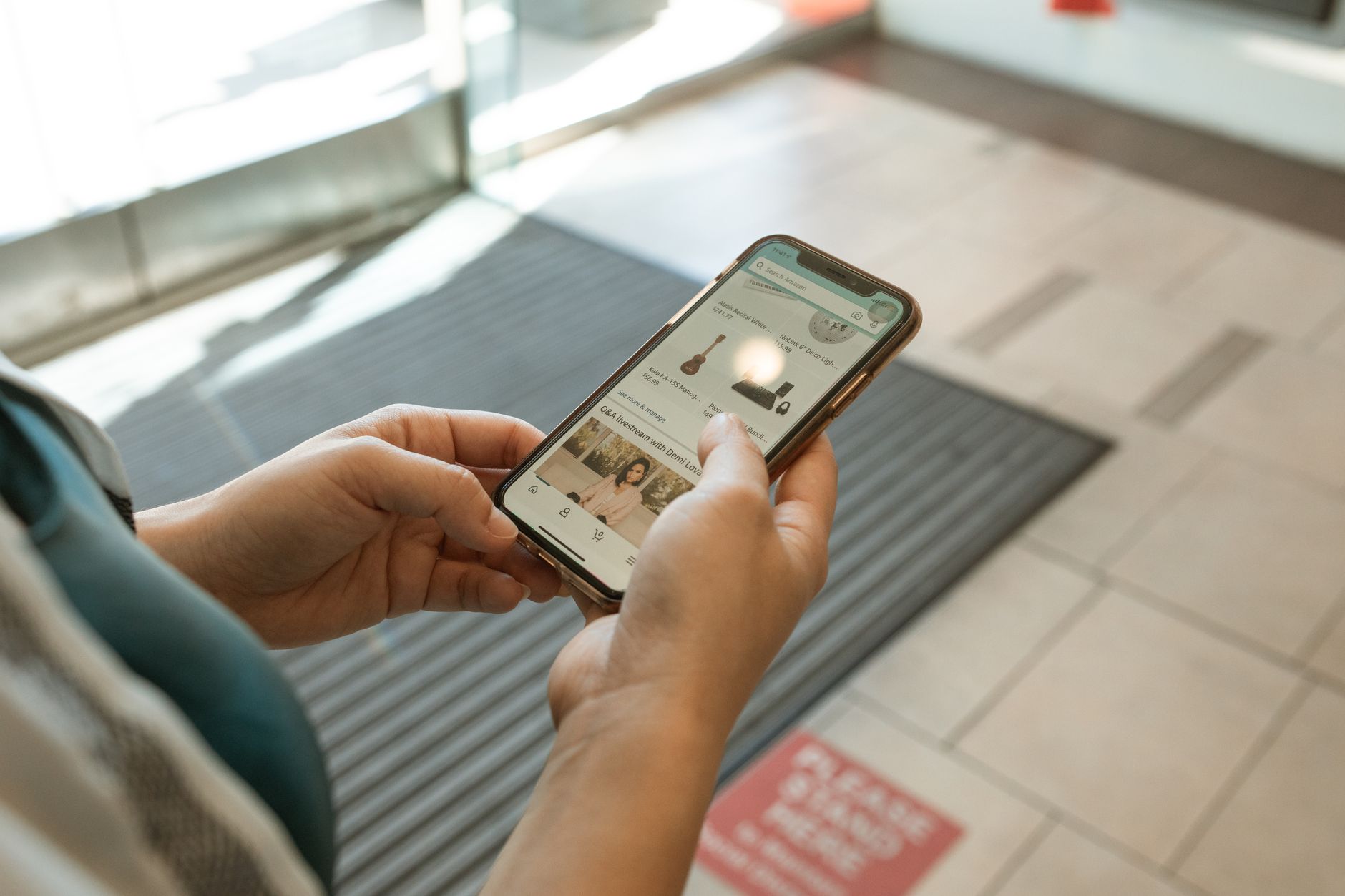 Person browsing an online sale on a smartphone