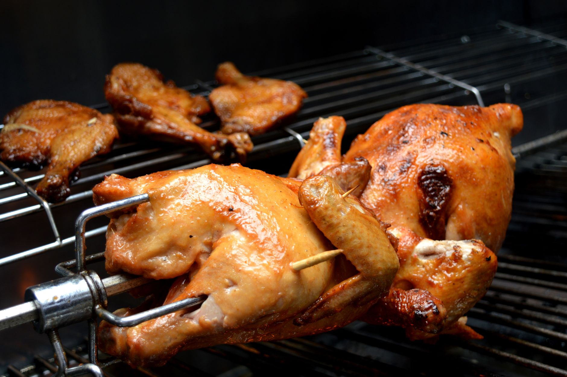 Raw whole chicken on a wooden cutting board in a home kitchen