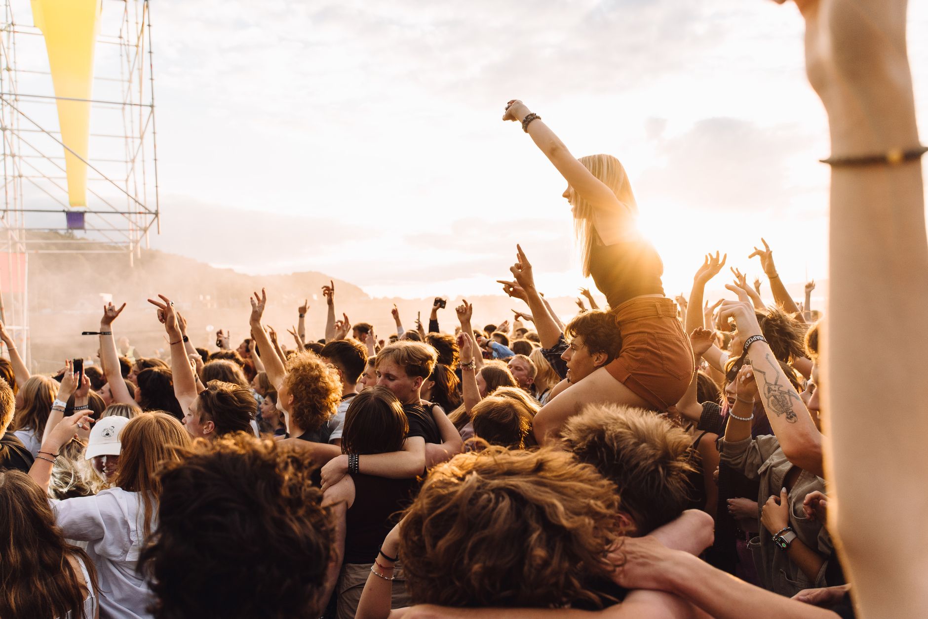 Urban summer concert crowd with diverse festival fashion