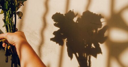 The Guilt of Leaving Someone Who Did Nothing Wrong Person sitting alone by a window looking reflective and tired