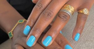 The Best Summer Nail Colors to Try in 2026 A collection of colorful nail polish bottles arranged on a light surface