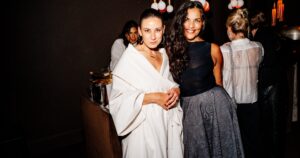Guests in stylish outfits at an intimate evening birthday party
