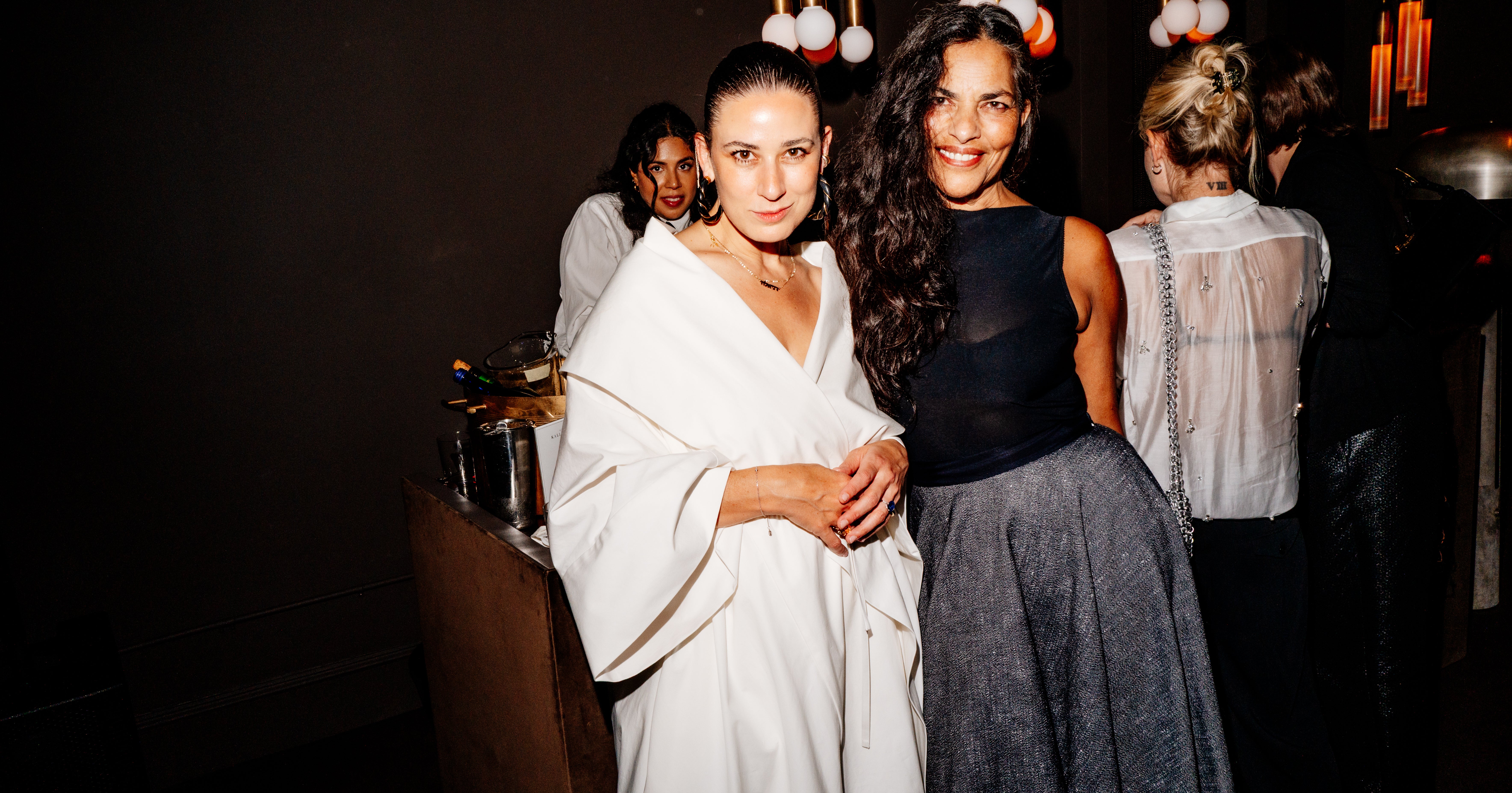 Guests in stylish outfits at an intimate evening birthday party