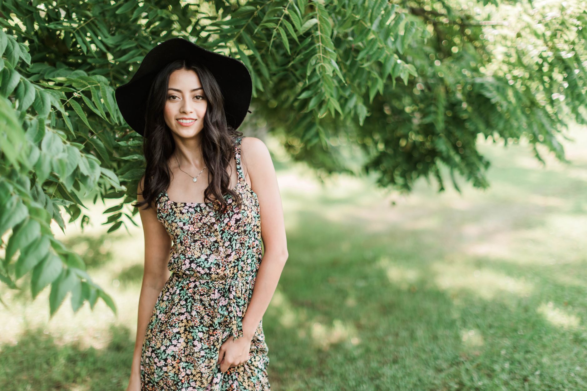 Woman wearing a floral maxi dress on a sunny beach