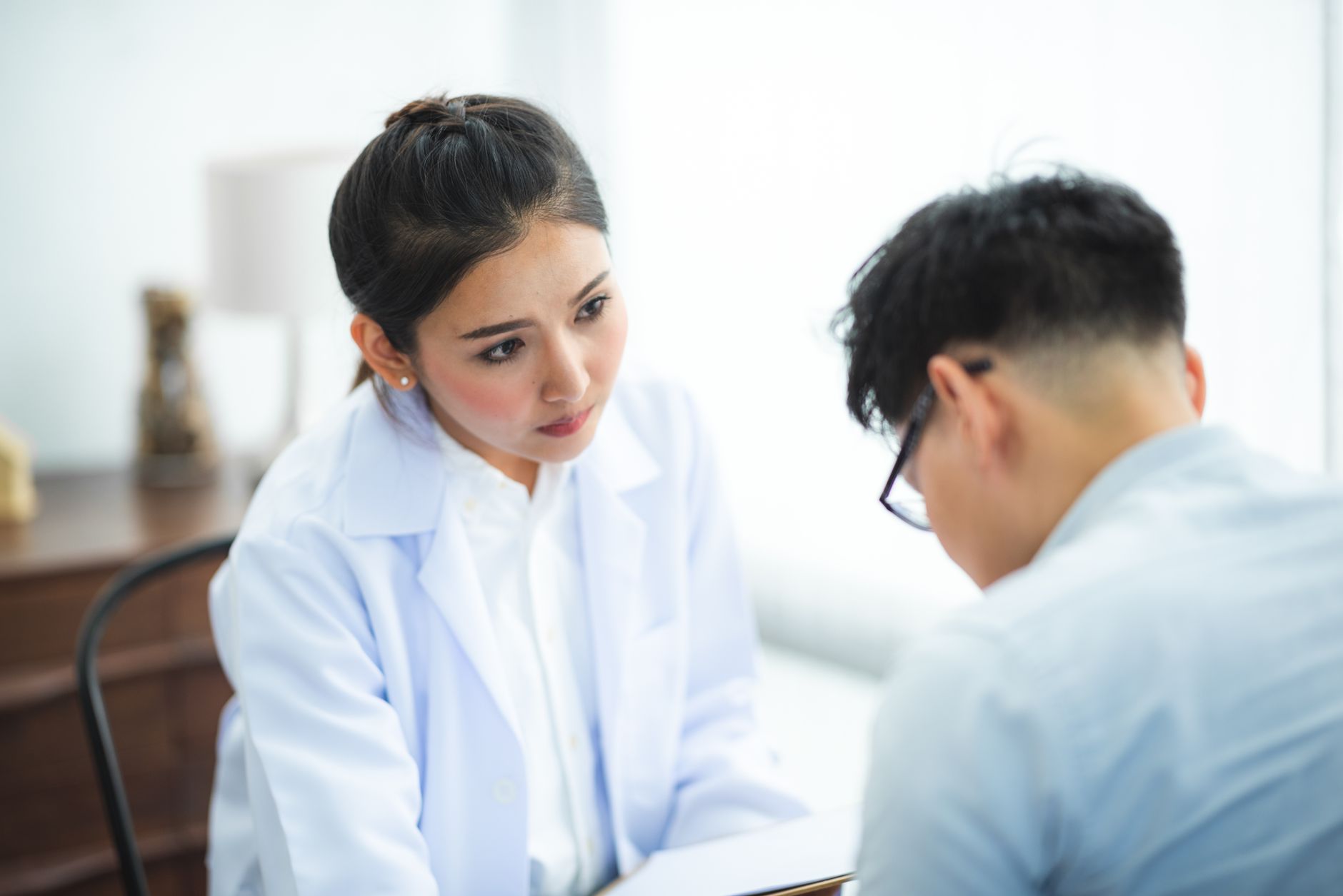 A woman speaking with a doctor during a medical consultation